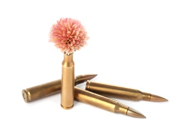 Photo of Bullets and cartridge case with beautiful flower isolated on white