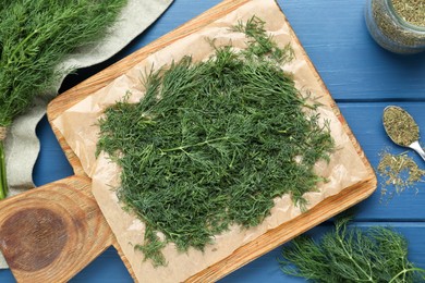 Flat lay composition with fresh dill preparing for drying on wooden table