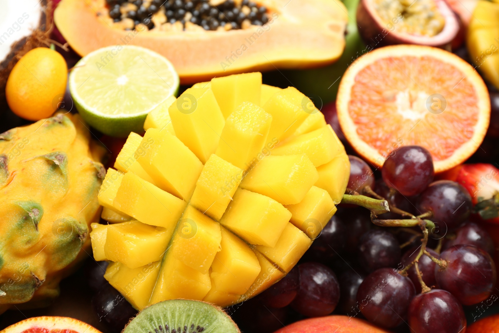 Photo of Many different delicious exotic fruits as background, closeup