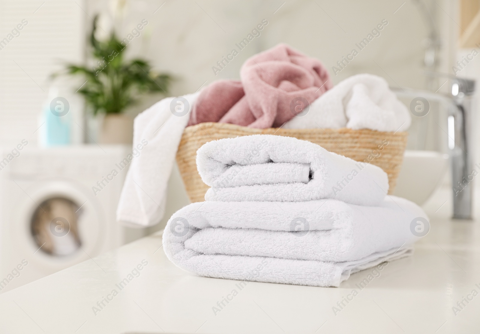 Photo of Clean towels on countertop in laundry room