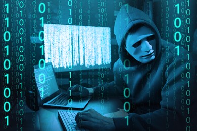Image of Anonymous man in mask with computers and binary code in darkness