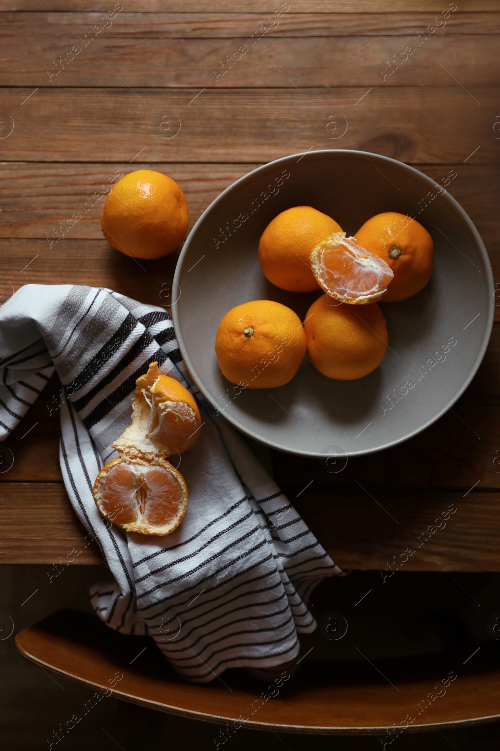 Photo of Fresh ripe tangerines on wooden table, flat lay