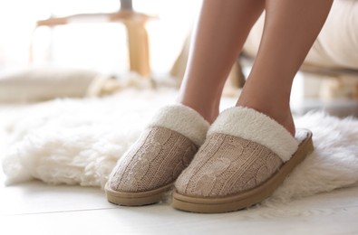 Photo of Woman wearing soft comfortable slippers at home, closeup