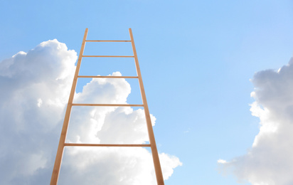 Wooden ladder against blue sky with clouds, low angle view