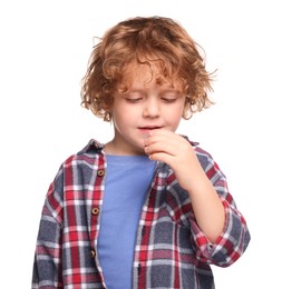 Photo of Cute boy drinking cough syrup from measuring cup on white background. Effective medicine
