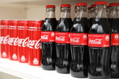 Photo of MYKOLAIV, UKRAINE - NOVEMBER 14, 2018: Coca-Cola cans and bottles on display in store