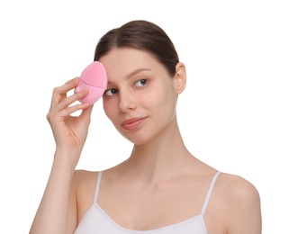 Washing face. Young woman with cleansing brush on white background