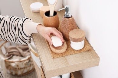 Bath accessories. Woman with soap indoors, closeup