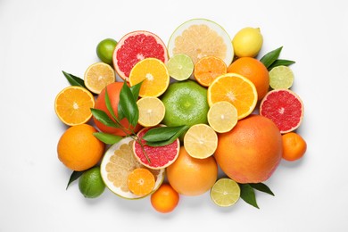 Photo of Different citrus fruits with fresh leaves on white background, top view