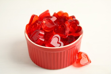 Tasty heart shaped jelly candies on white background