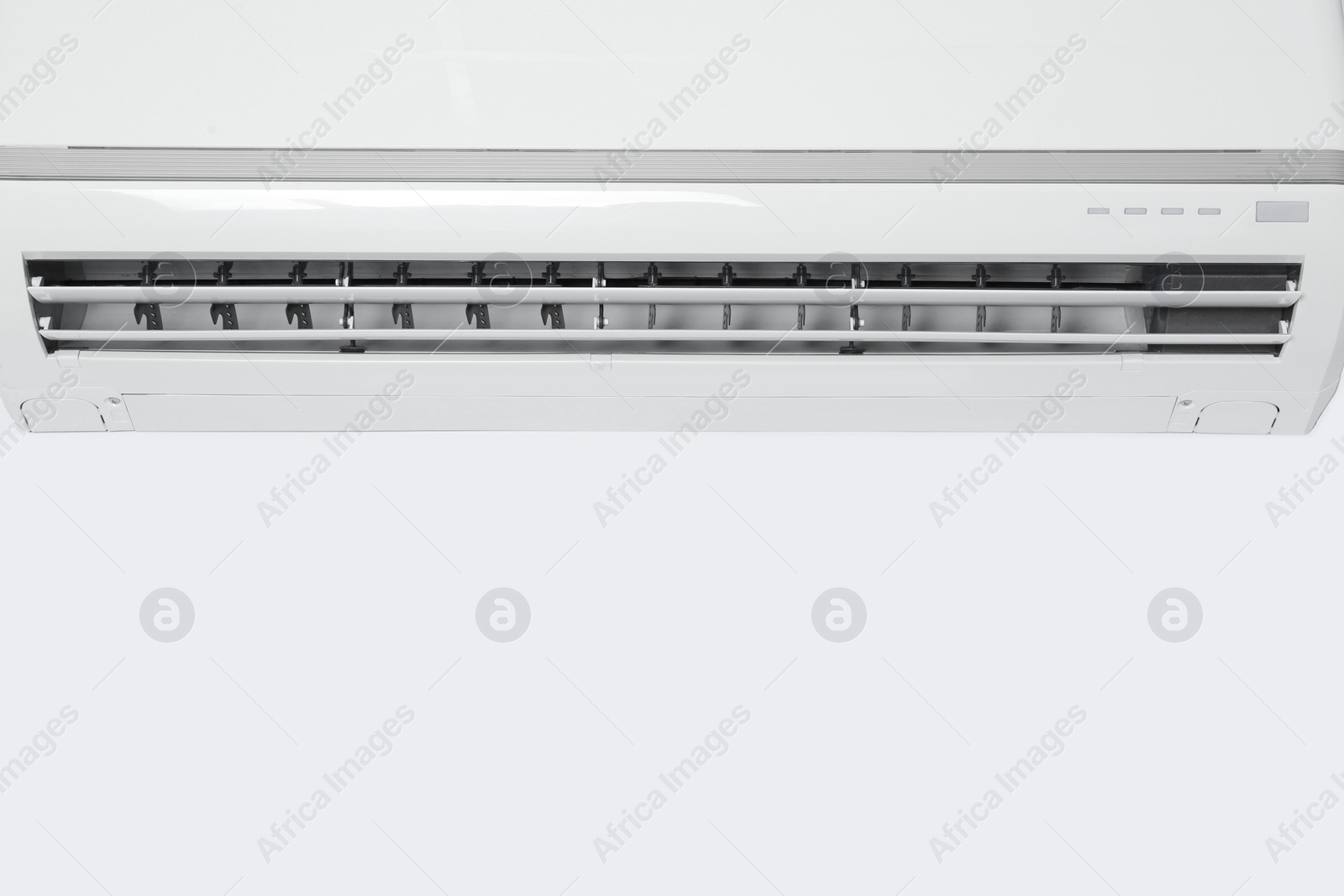 Photo of Modern air conditioner on white wall. Space for text