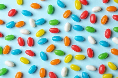 Photo of Flat lay composition with delicious jelly beans on color background