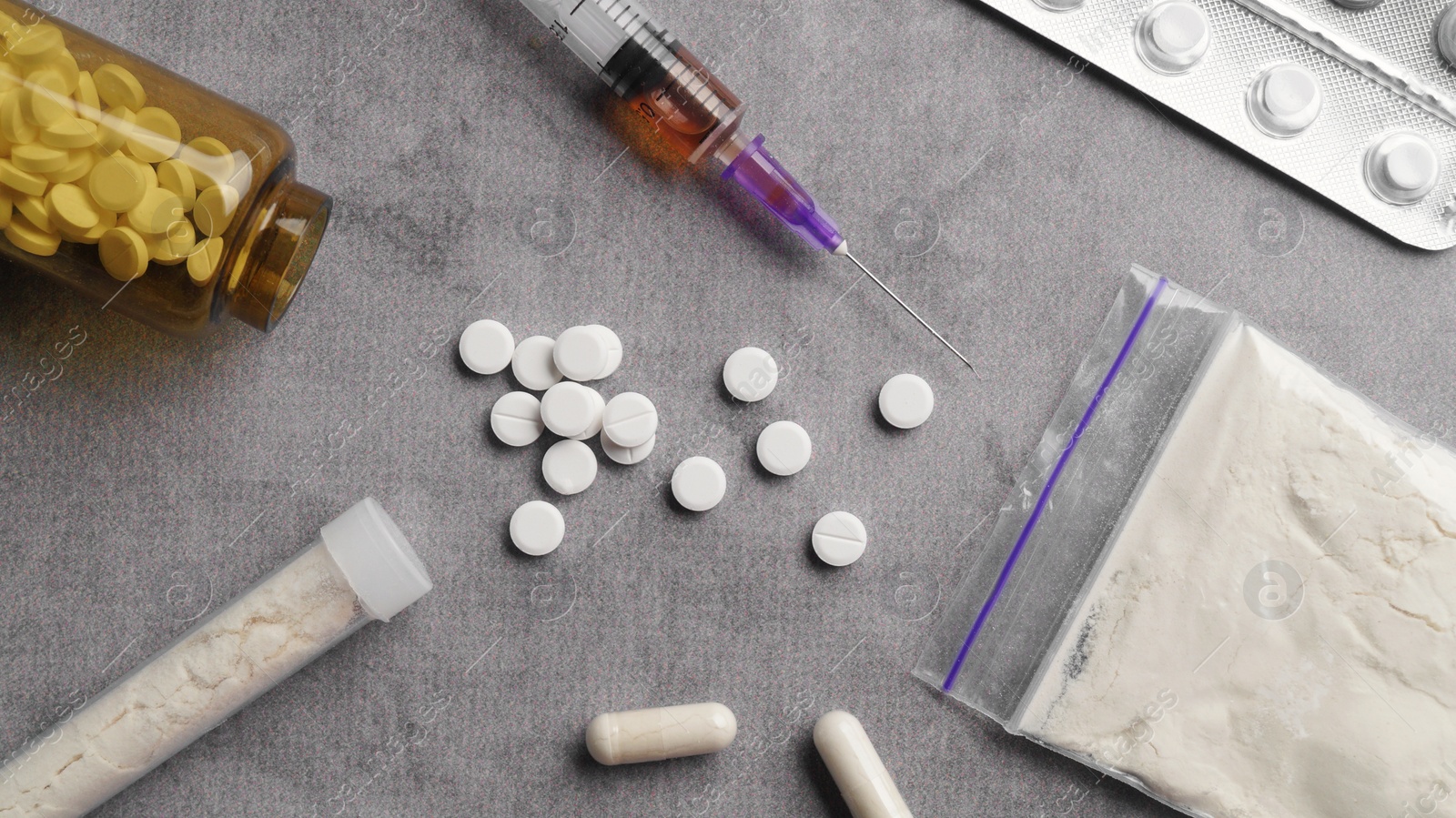 Photo of Many different hard drugs on light grey table, flat lay