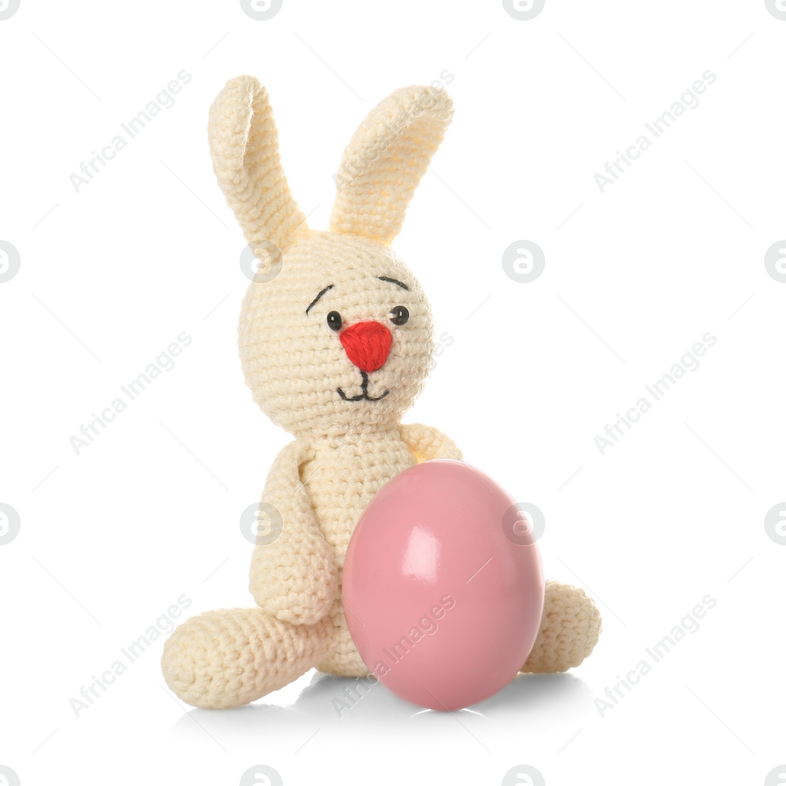 Photo of Cute Easter bunny toy and dyed egg on white background