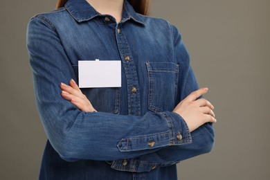 Photo of Woman with blank badge on grey background, closeup