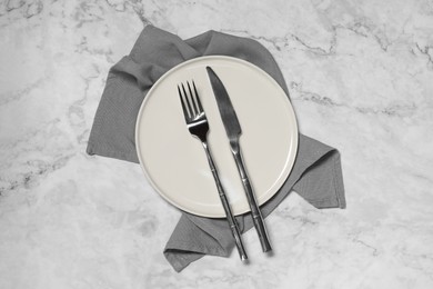 Photo of Stylish setting with elegant cutlery on white marble table, top view