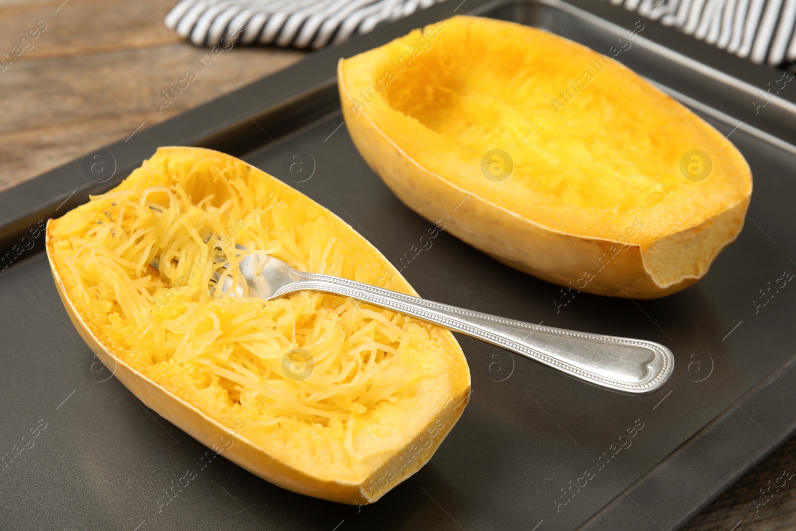 Photo of Cooked spaghetti squash and fork on baking sheet