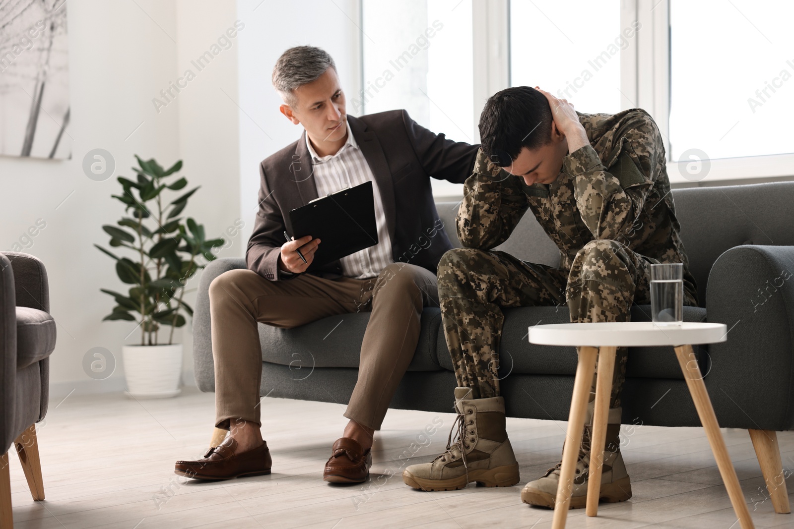 Photo of Professional psychotherapist working with military man in office