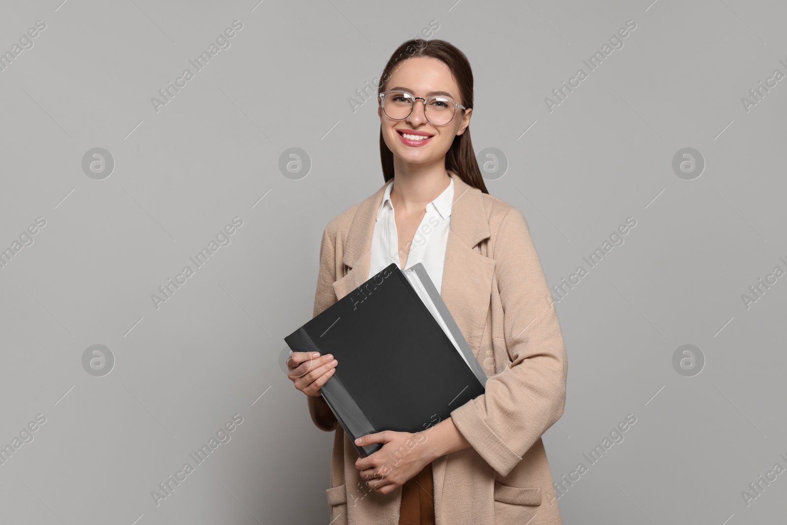 Photo of Portrait of beautiful young teacher on grey background