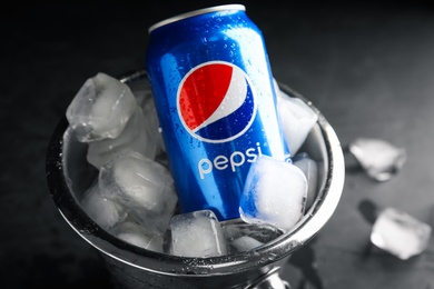 MYKOLAIV, UKRAINE - FEBRUARY 11, 2021: Can of Pepsi and ice cubes in bucket, closeup