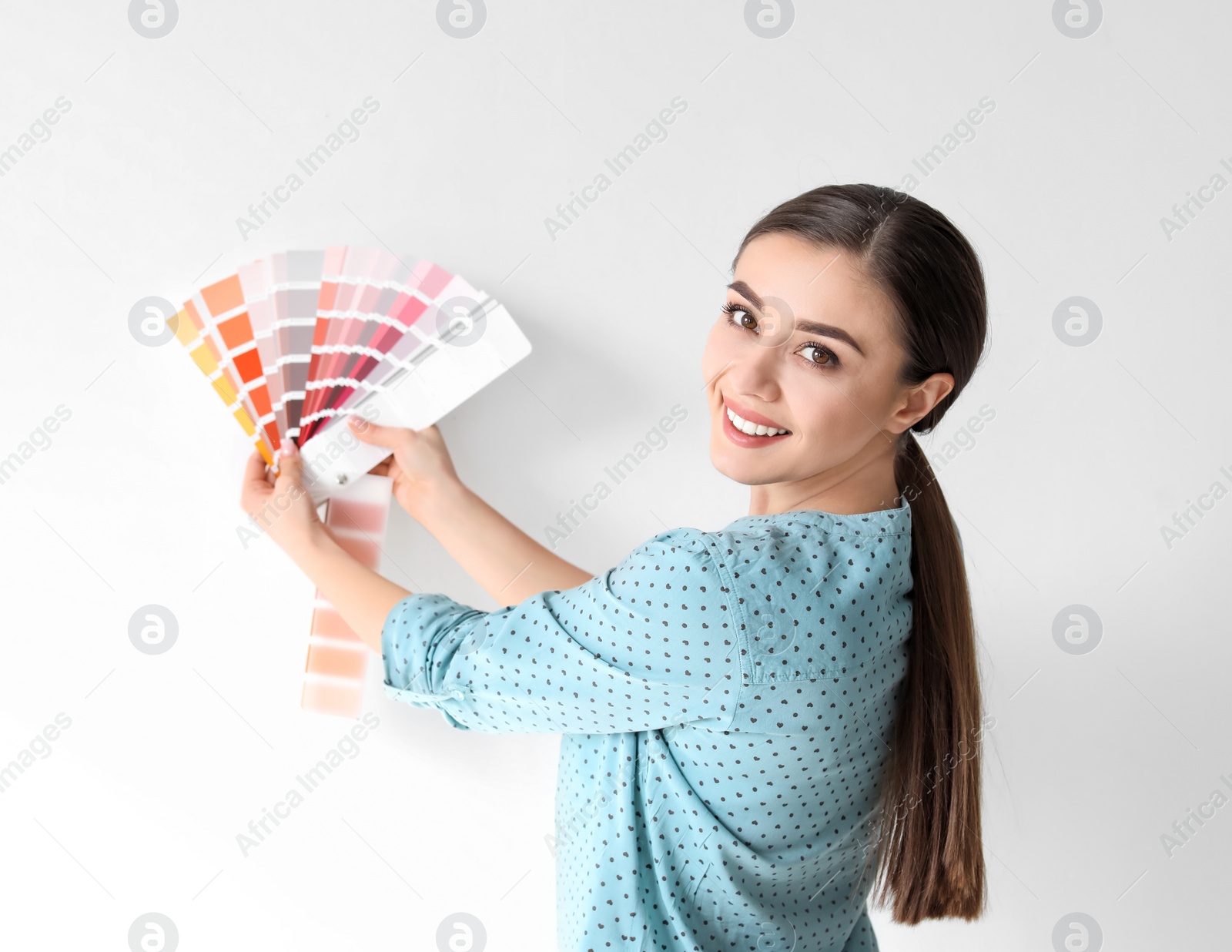 Photo of Young woman with color palette on white background