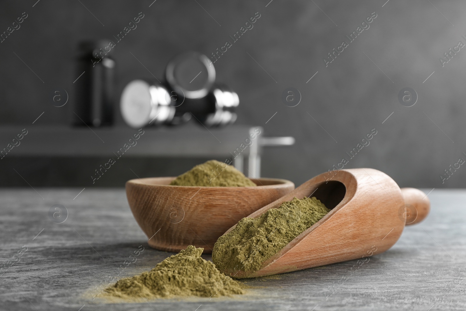 Photo of Bowl and scoop with hemp protein powder on table. Space for text