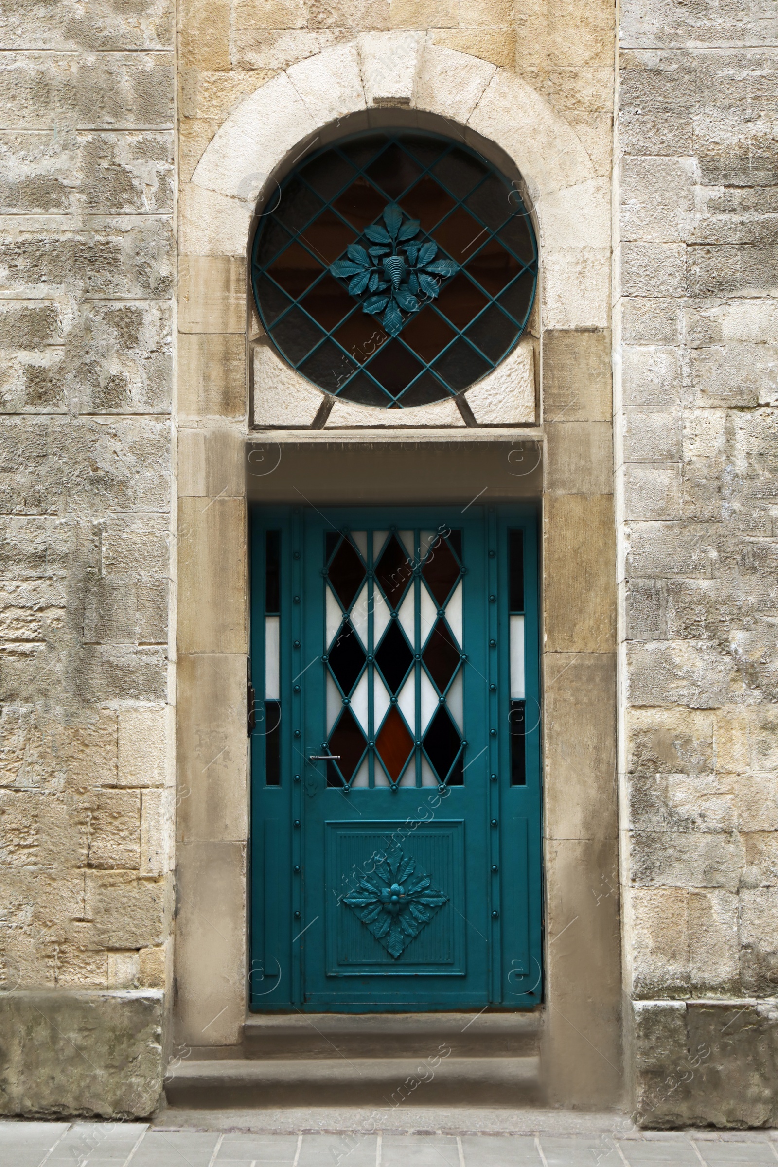 Photo of View of building with blue leaded glass door. Exterior design