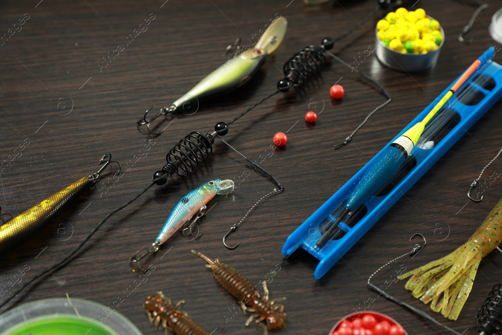 Photo of Fishing tackle on dark wooden background, closeup