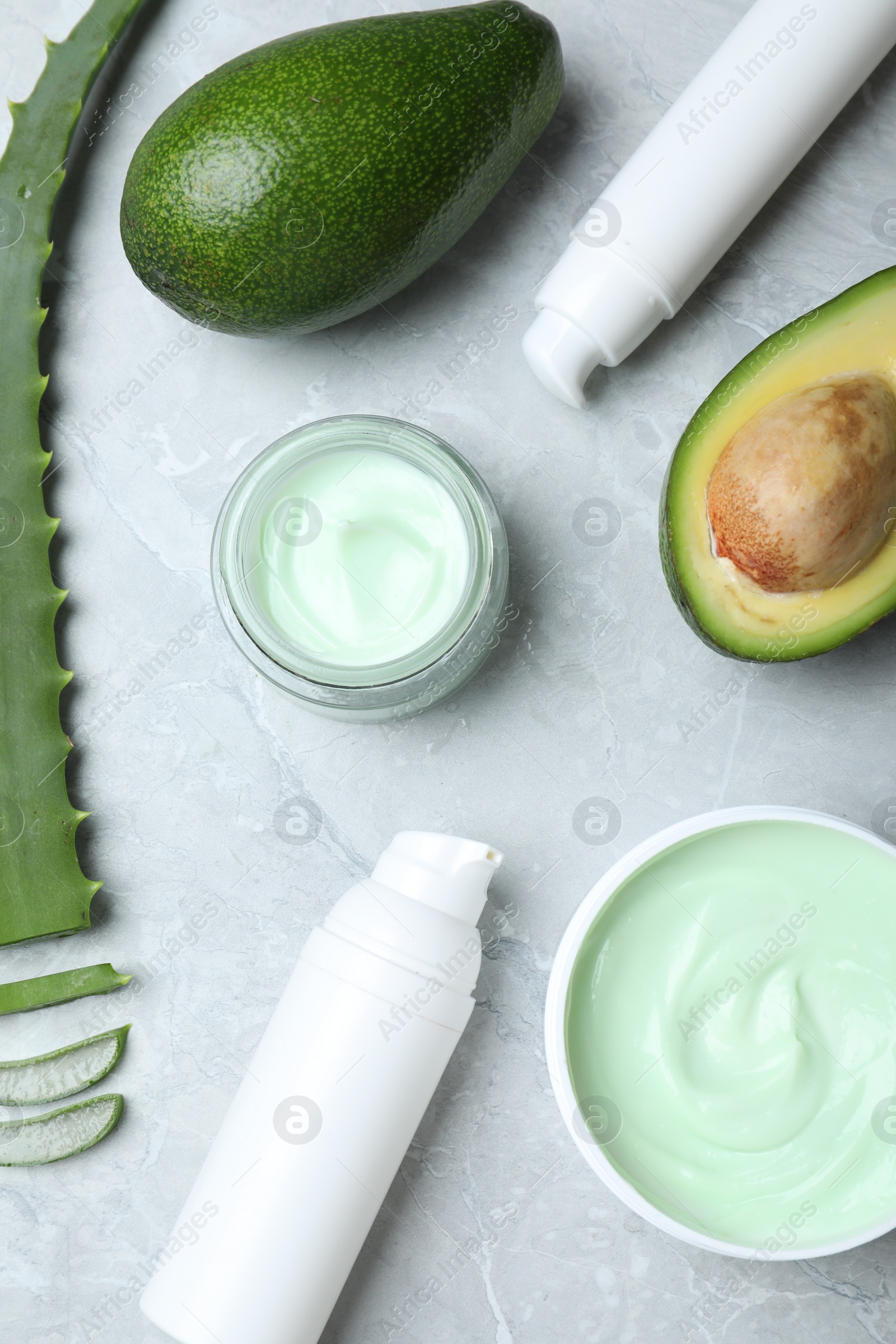 Photo of Flat lay composition with jars of cream on marble background