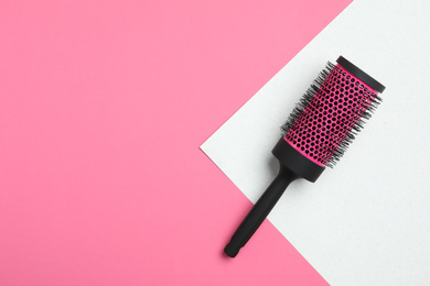 Round hair brush on color background, top view. Space for text