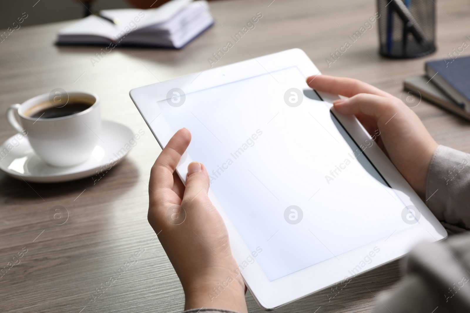 Photo of Woman with modern tablet at table in office, closeup