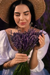 Photo of Beautiful young woman with lavender bouquet outdoors, closeup