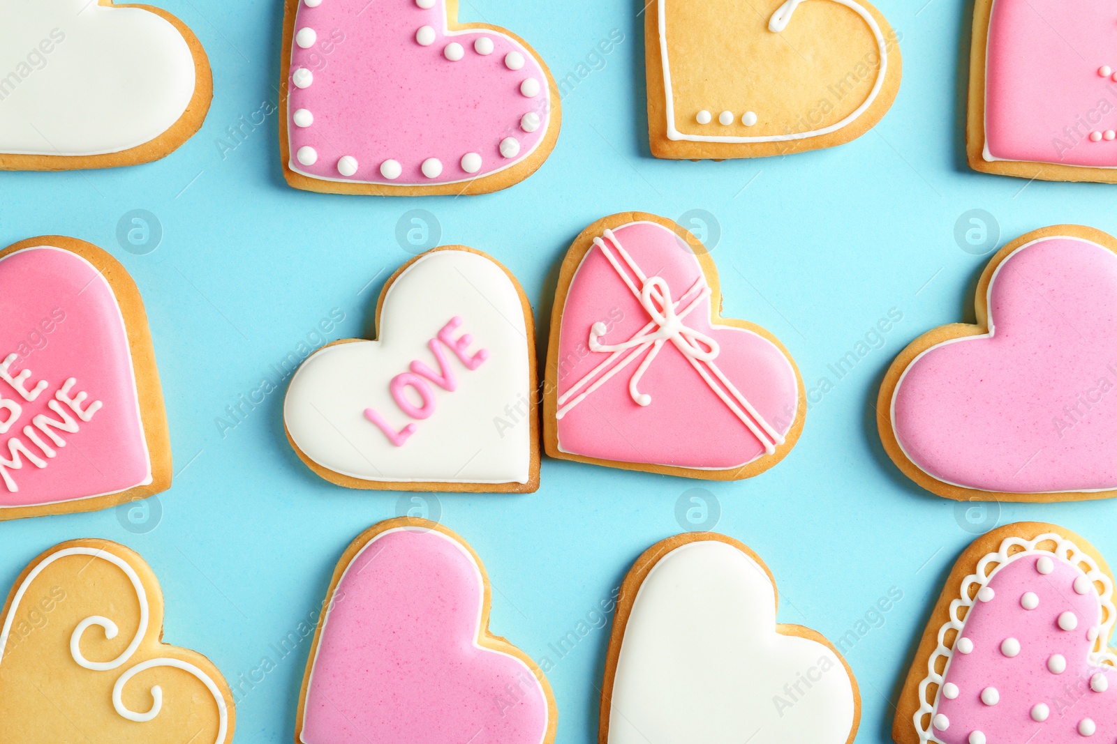 Photo of Decorated heart shaped cookies on color background, top view. Valentine's day treat