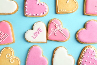 Photo of Decorated heart shaped cookies on color background, top view. Valentine's day treat