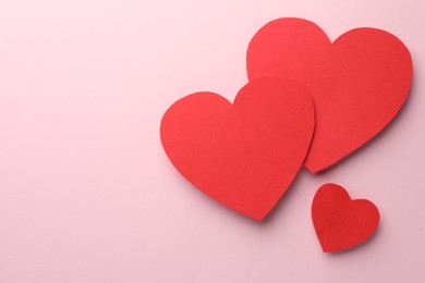 Photo of Paper hearts on pink background, flat lay. Space for text