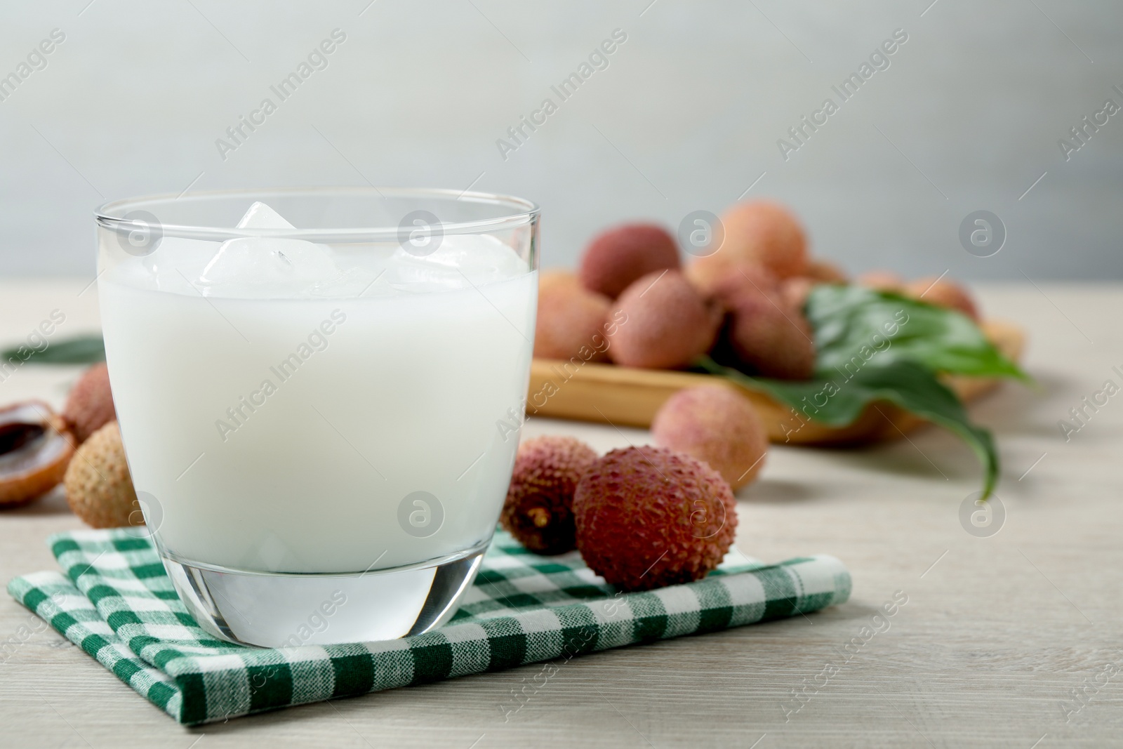 Photo of Fresh lychee juice on white wooden table