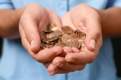 Young woman holding pile of coins, closeup view