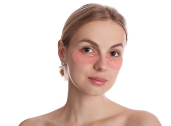 Photo of Beautiful young woman with pink under eye patches on white background