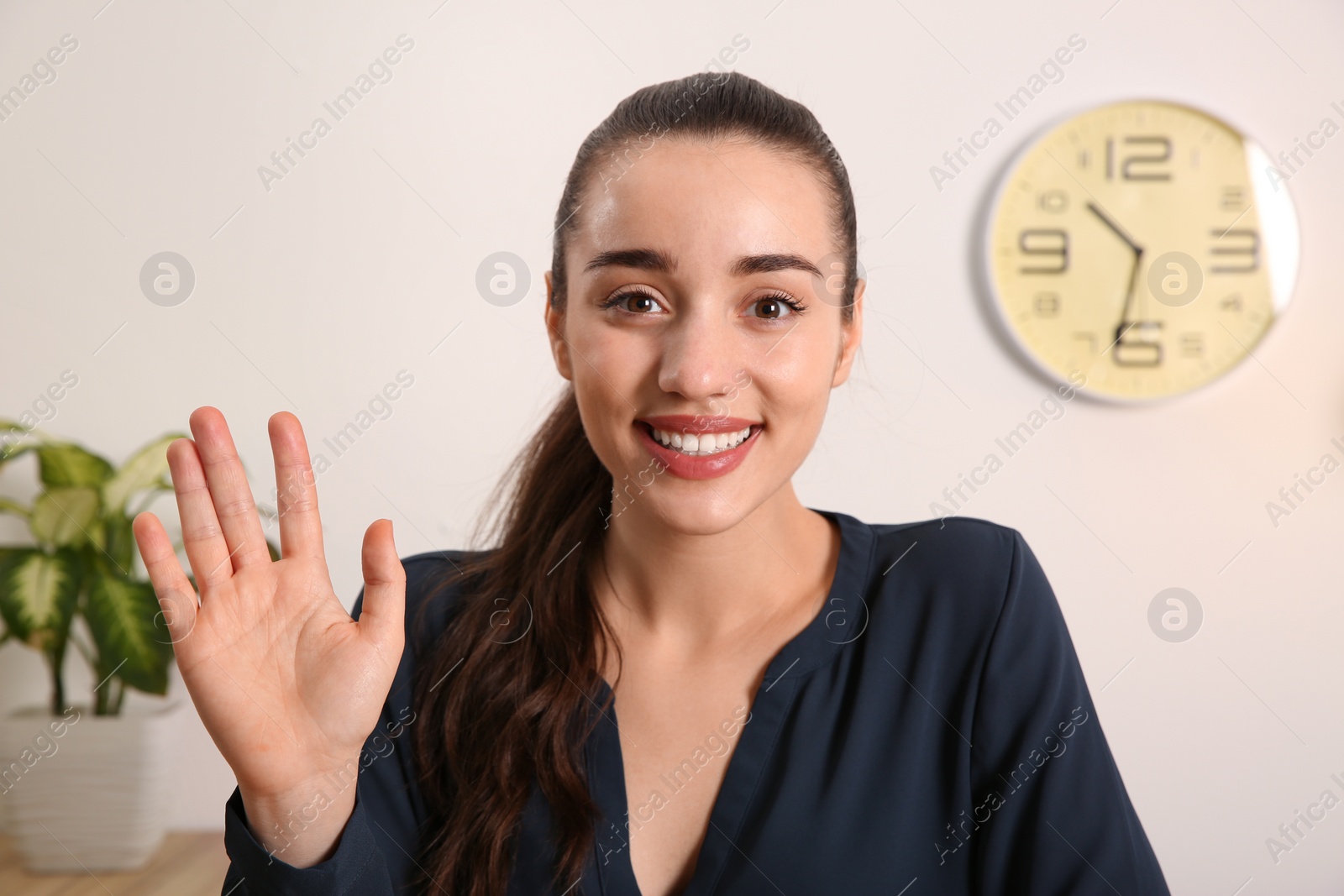 Photo of Young woman using video chat indoors, view from web camera