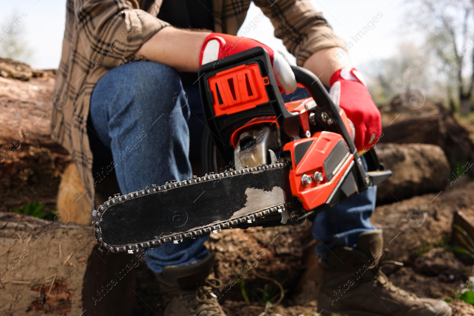 Photo of Man with modern electric saw outdoors, closeup