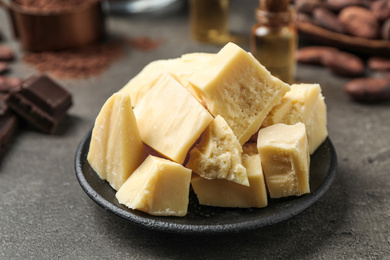 Organic cocoa butter on grey table, closeup