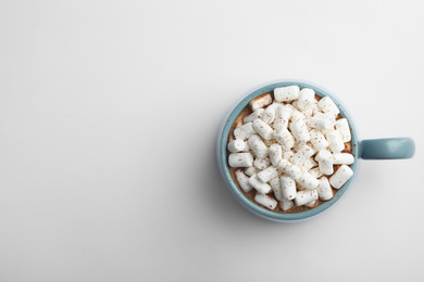 Delicious cocoa drink with marshmallows on white background, top view