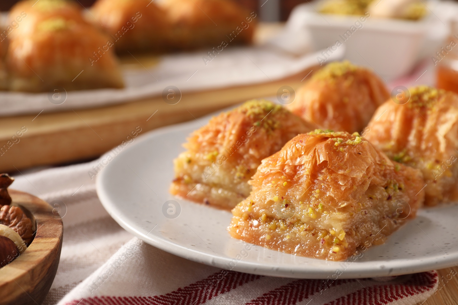 Photo of Delicious sweet baklava with pistachios on table, closeup