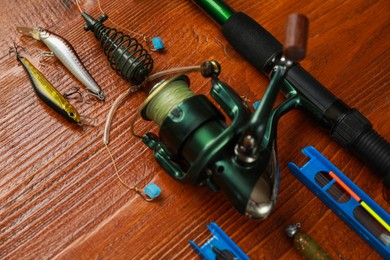Photo of Fishing tackle on wooden table, closeup view