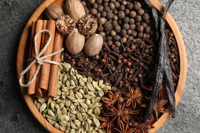 Photo of Different spices and nuts on gray table, top view