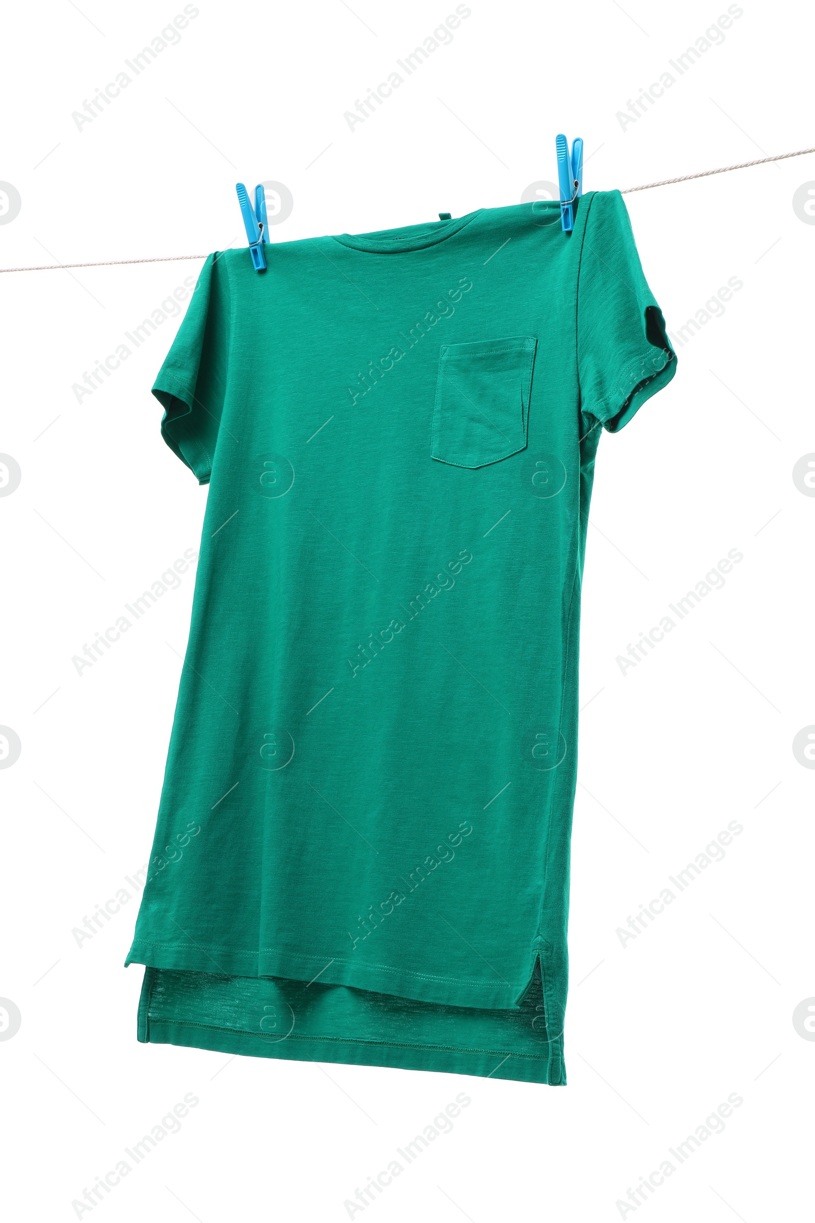 Photo of One green t-shirt drying on washing line isolated on white