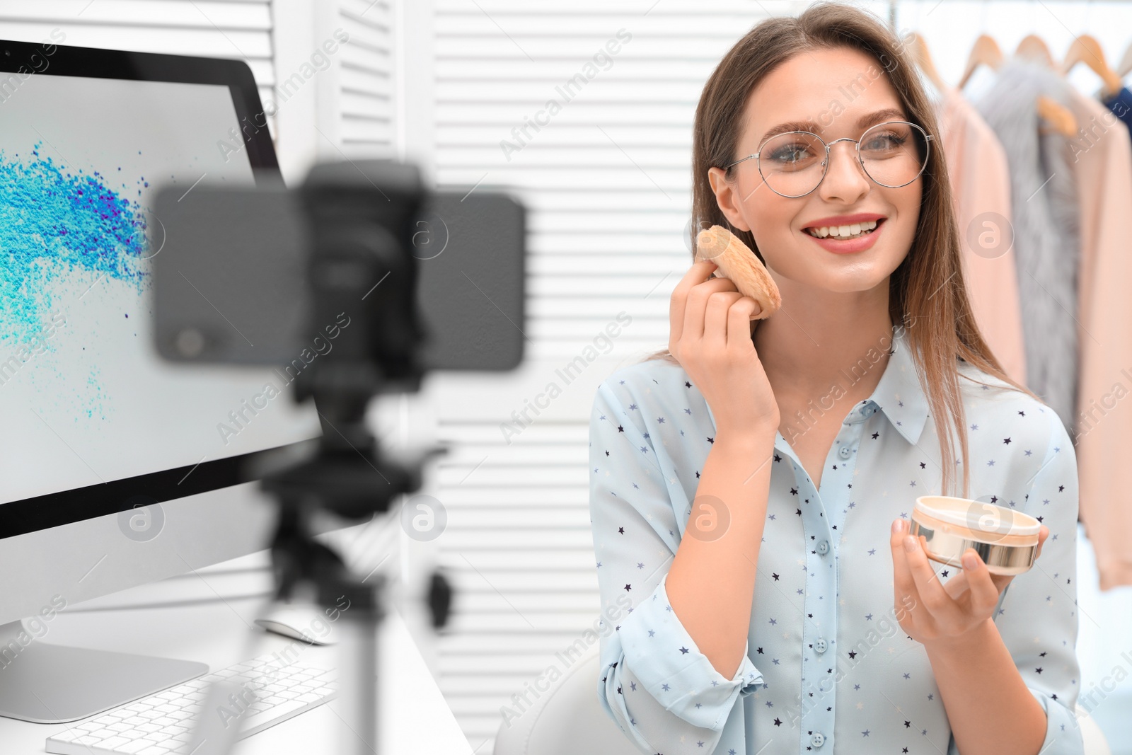 Photo of Beauty blogger filming make up tutorial at home