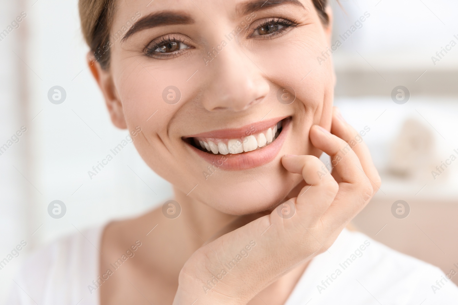 Photo of Young woman with beautiful smile indoors. Teeth whitening