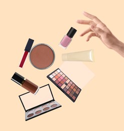 Image of Woman making decorative cosmetics levitate on beige background, closeup. Makeup products