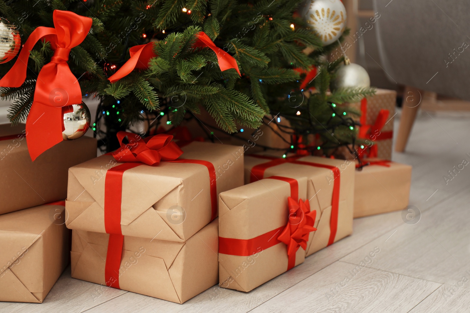 Photo of Beautiful Christmas tree with gifts in living room